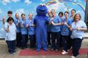 The Cookie Monster with staff nurse Nicole Skinner and some of the team at the children's ward at the Vic.
