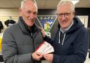 Douglas Chapman (right) receives his tickets for the Dunfermline City Fan Zone from Pars legend Roy Barry.