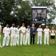 Members of Dunfermline and Carnegie's first XI with Fife Provost, Jim Leishman, at the unveiling of a scoreboard in memory of late club stalwart Tom Gibson. It took place prior to the rained off match with Holy Cross. Photo: Dave Wardle.