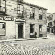 Cash Stores, James Kyle menswear store and, just visible, Coull and Matthew ironmongers shop, pictured in 1927.
