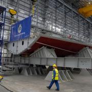 A worker passing the keel before the keel laying ceremony for the first type 31 frigate at Rosyth.