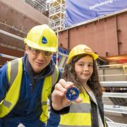 Electrical fitter Robbie Dick and coin designer Jessica Davidson, aged 7, at the keel laying ceremony for HMS Active.