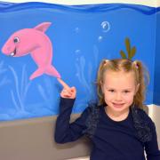 Little Poppy Chalmers with the soothing new artwork in Victoria Hospital.