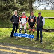 Niall Mackenzie, pictured with son Taylor, and Knockhill's Jillian Shedden and Stuart Gray, saw the road to the venue named in his honour.