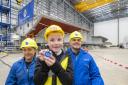 Coining it in. Babcock apprentices Naimh Charleston and Ian Stevenson with Josh Duffy (7) who designed the coin for the keel laying ceremony at Rosyth.
