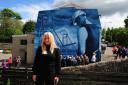 Donna Forrester with her painting on the side of the White Gates pub in Comrie. Pic: David Wardle