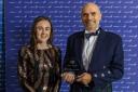 Pitreavie's Paul Allan collects the club's award from Laura Muir at the Scottish Athletics Annual Awards in 2021. Photo: Bobby Gavin.