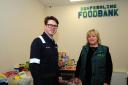 Dunfermline foodbank - Sandra Beveridge shows Tom Antram from EXXON what they do