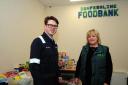 Dunfermline foodbank - Sandra Beveridge shows Tom Antram from EXXON what they do.