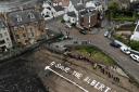 The North Queensferry residents campaigning to buy the Albert Hotel spell out their message on the beach. Image: Mike Dooley