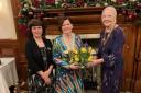 President Wendy Spence on the right presenting flowers to Chairman Annetta in the middle and singer/songwriter Margaret Farquarson.