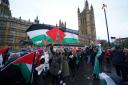 People take part in a Palestine Solidarity Campaign rally outside the Houses of Parliament (Lucy North/PA)