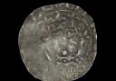 The silver penny depicts Malcolm IV of Scotland, with his face just about visible.