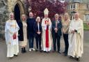 Richard and wife Elaine with their family, along with Archbishop Cushley (centre) Canon Paul Kelly (right) and Deacon Douglas Robertson, after Mass at St Michael's in Linlithgow.
