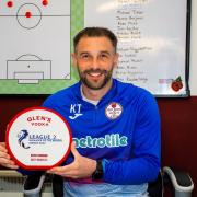 Kevin Thomson shows off his manager of the month award.