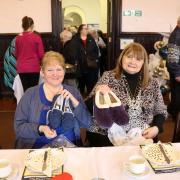 Two of our Senior Sessions guests with their brand new slippers. Image: Fife Housing Group