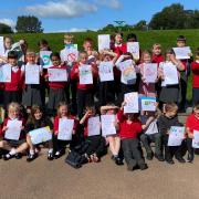 Commercial Primary pupils with their posters urging dog owners to pick up their pets' poo.
