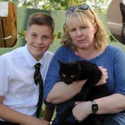 Fiona Scott and son Matthew with one of their remaining cats in their garden where an anonymous note was left. Top right: Janice Ryan's cat Trigger who died suddenly on Friday.