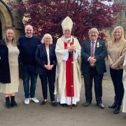 Richard and wife Elaine with their family, along with Archbishop Cushley (centre) Canon Paul Kelly (right) and Deacon Douglas Robertson, after Mass at St Michael's in Linlithgow.