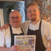 Bryan and Jack holding their copy of The Times