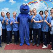 The Cookie Monster with staff nurse Nicole Skinner and some of the team at the children's ward at the Vic.