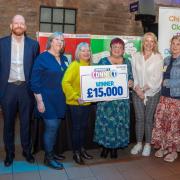 The Children's Clothing Bank Dunfermline team celebrate the £15,000 Scotmid funding boost.