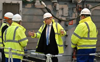 Prime Minister Boris Johnson is shown a vessel undergoing refit for the Ukrainian Navy during a visit to Rosyth Dockyard